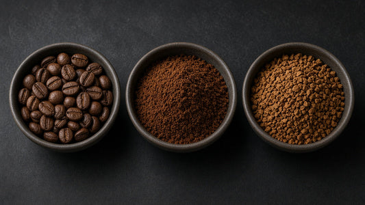 Three bowls comparing whole coffee beans, ground coffee and instant coffee